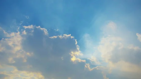 Sunlit clouds in a clear blue sky Stock Footage 306028497