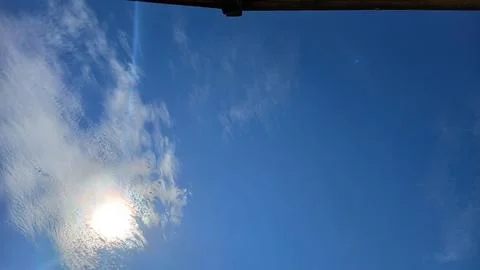 Sunlit Clouds in a Clear Blue Sky 스톡 사진