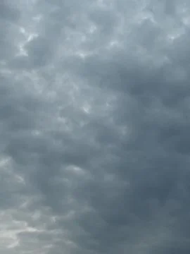 Sunlit Clouds in a Gray Sky Stock Photos