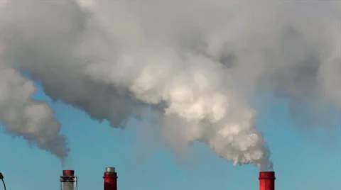 Sunlit clouds of pure steam from three stacks on light blue sky background. Stock Footage 38614572