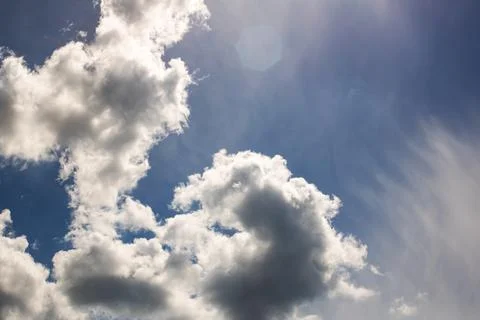Sunlit clouds in the sky and trees Stock Photos