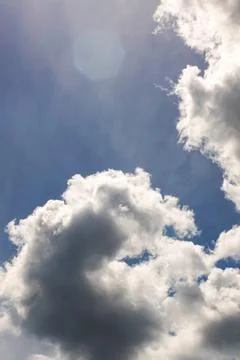 Sunlit clouds in the sky and trees Stock Photos