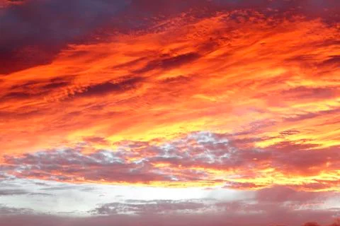 Sunlit clouds in summer sky Stock Photos