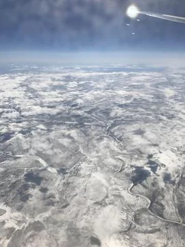 Sunlit cloudscape viewed from a passenger airplane Foto stock