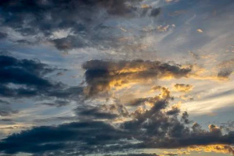 Sunlit cloudy sky. Sunset Stock Photos