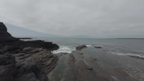 Sunlit coastal cliffs and calm blue atlantic ocean water in ireland Stock Footage 340457506