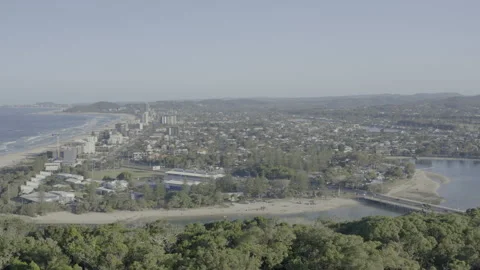 Sunlit Coastal Townscape Beach, Estuary, Bridge and Suburban Sprawl 4K HDR Stock Footage 310464591