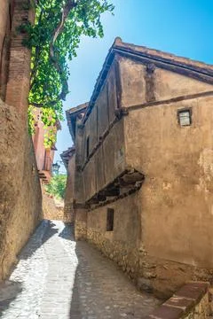 Sunlit Cobblestone Lane in Albarracin Stock Photos