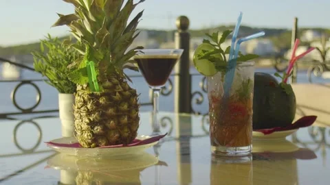 Sunlit cokctials on a table with sea in the background Stock Footage 140056528
