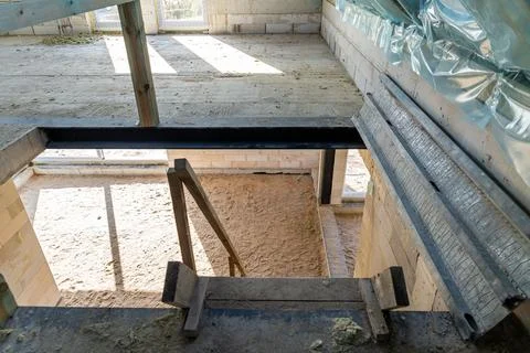 Sunlit corner of a room in an under-construction house with exposed concret.. Stock Photos