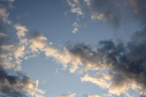 Sunlit Cumulus Clouds in Blue Evening Sky Stock Photos