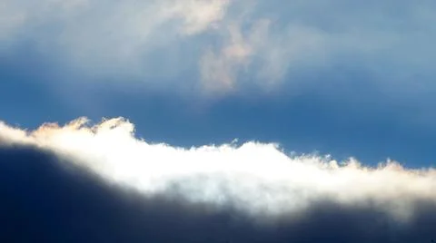 Sunlit dark snow cloud for sky background Stock Photos