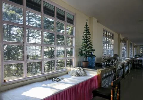 Sunlit dining area with large glass windows, buffet counter Stock Photos