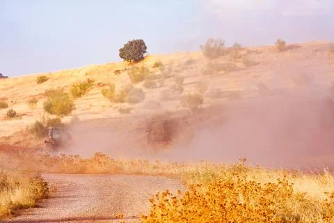 Sunlit Dust Cloud Over the Rural Hills of Alhambra Stock Photos