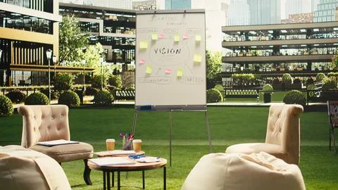 Sunlit empty office terrace prepared for outdoor strategy meeting Stock Photos
