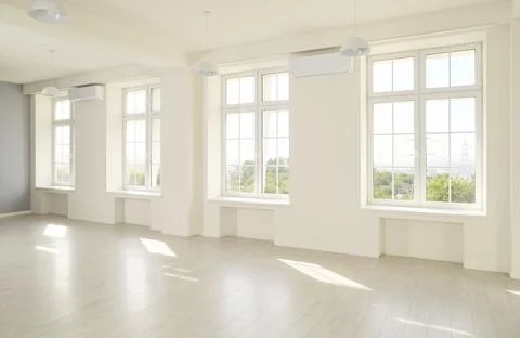 Sunlit Empty White Studio Interior with Large Windows and Wood Floor Space Stock Photos