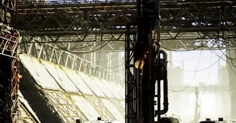 Sunlit industrial landscape with complex structures and cables Stock Illustration