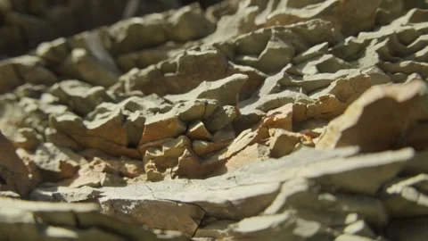 Sunlit Layered Rock Formation in a Mountain Landscape Stock Footage 289840233