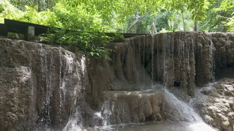 Sunlit Limestone Waterfall Ledge Beneath Dense Foliage In Thailand 스톡 동영상 339083129
