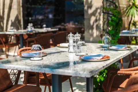 Sunlit Marble Table Setting on a Restaurant Terrace in Tivat Stock Photos
