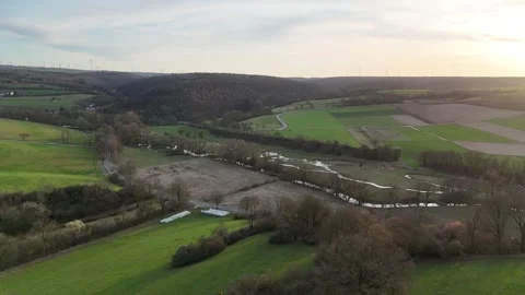 Sunlit meadow with stream road and rural lens flare Stock-Footage 331210910
