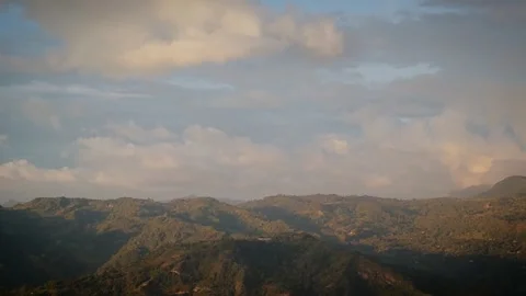 Sunlit mountain range under dramatic morning clouds Video stock 316797364