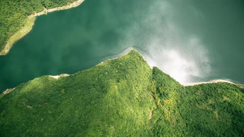 Sunlit Mountain Ridges and Reflective Water Surface Aerial Stock Footage 320817631