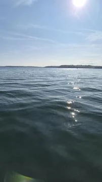 Sunlit Ocean Water Surface with Distant Horizon Photos