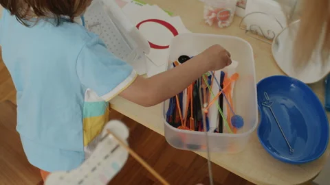 In a sunlit office, a little learner and her tutor in white coat share smiles Stock Footage 272946541