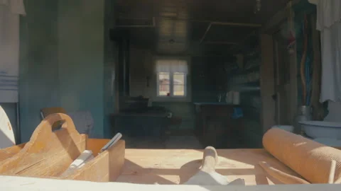 Sunlit Old Kitchen Tools on a Rustic Wooden Kitchen Table Stock Footage 334499413
