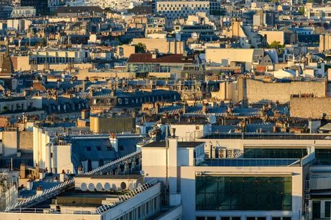 Sunlit Paris rooftops and dense urban landscape 스톡 사진