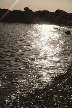Sunlit Path on Ocean Surface at Sunset Stock Photos