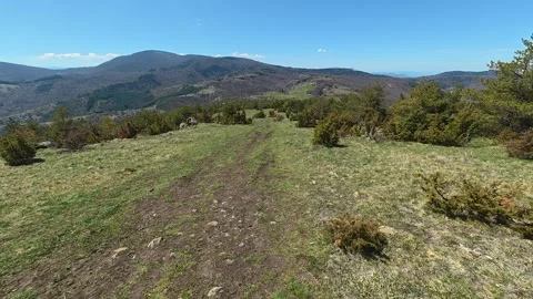 Sunlit path winds through grassy hillside. Balkan, Eastern Europe, POV 스톡 동영상 333441583
