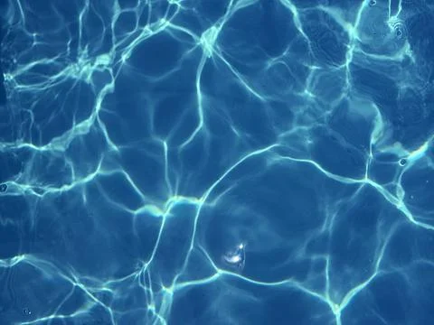 Sunlit Patterns on Blue Pool Water Stock Photos