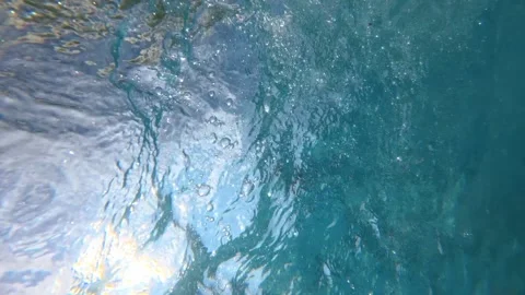 Sunlit pool water bubbling and swirling beneath surface Stock Footage 342160732