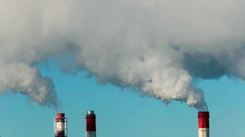 Sunlit puffy clouds of pure steam from three stacks on light blue sky background Stock Footage 38614938