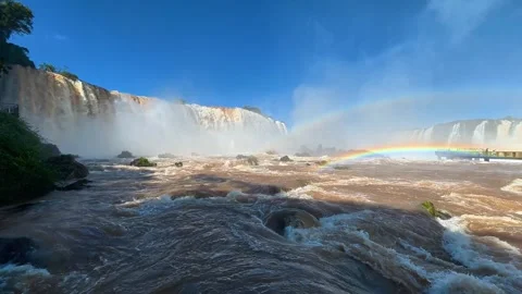 Sunlit Rapids Flow Beneath a Rainbow at Brazil’s Iguazu Falls Video stock 342275634