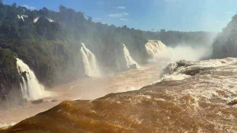 Sunlit Rapids Sweeping Across Layered Cascades at Brazil’s Iguazu Falls Stock Footage 342275417