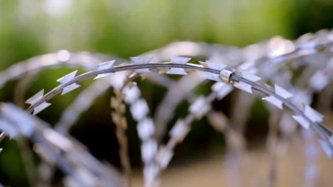 Sunlit Razor Tape Blades on Curved Coil, Macro Shot Stock-Footage 344122365