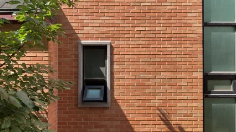 Sunlit Red Brick Wall with Small Open Window and Tree Shadows 스톡 동영상 347290275
