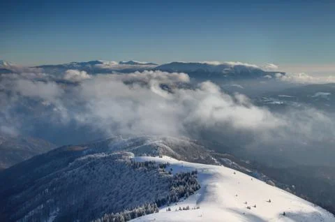 Sunlit ridges of Velka Fatra and Nizke Tatry above the clouds Stock Photos