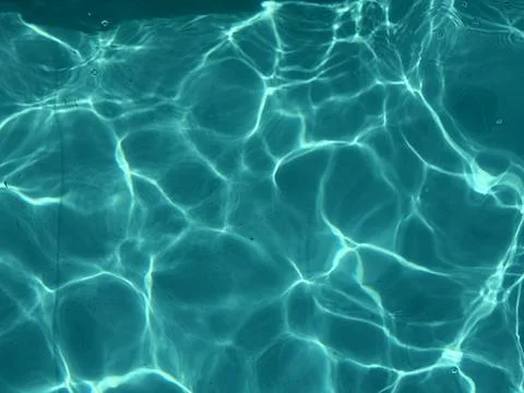 Sunlit Ripples on Blue Pool Surface Stock Photos