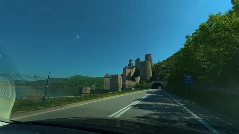 Sunlit road leads to ancient castle. Balkan, Eastern Europe, POV Vídeos de archivo 333344139