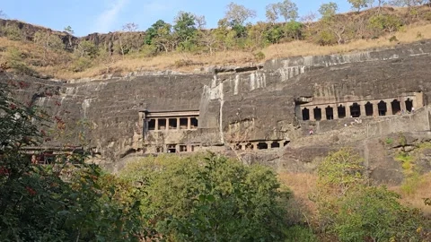 Sunlit Rock-Cut Cave Row In Basalt Cliff, Ajanta Caves, Maharashtra, India 8K Stock Footage 256913223