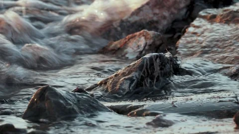 Sunlit Rocks Washed by Surf During Dusk Stock-Footage 342016371