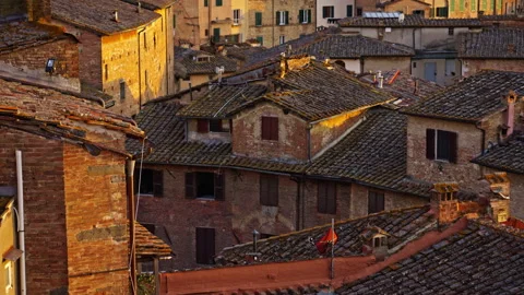 Sunlit Rooftops with Weathered Tiles and Warm Evening Architectural Detail Stock Footage 256237346