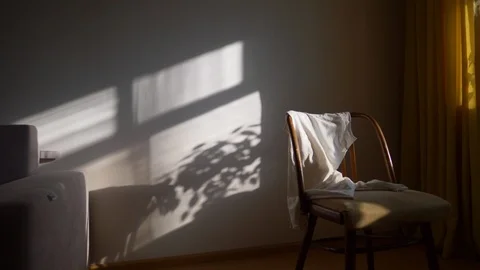 Sunlit room with big window and chair, sofa, potted plant, early morning in cozy 스톡 동영상 121757601