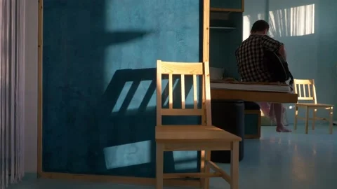 Sunlit room in modern apartment, lockdown self isolation concept, man playing Stock Footage 157937557