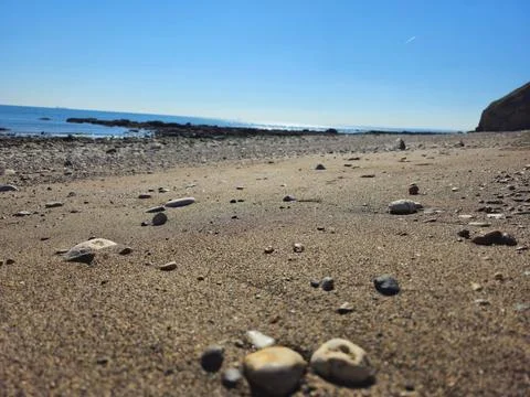 Sunlit Sand and Pebbles at Easington Colliery Beach Stock Photos