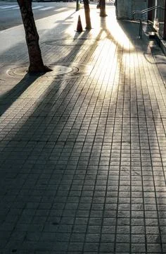 Sunlit sidewalk Stock Photos